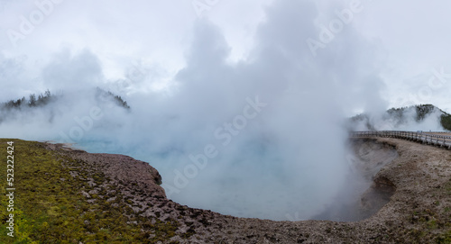 Hot spring Geyser with colorful water in American Landscape. Cloudy Sky. Yellowstone National Park, Wyoming, United States. Nature Background Panorama © edb3_16