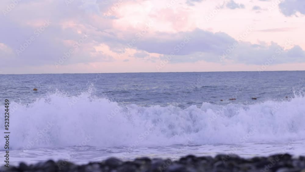 Splashing waves on the pebbly beach On the Sunset Splashing waves on the pebbly beach On the Sunset