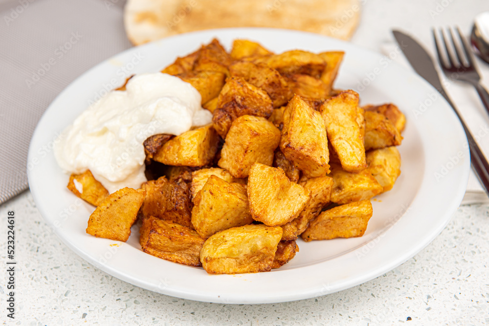 Baked potato wedges on white table background Baked potato wedges on white table background