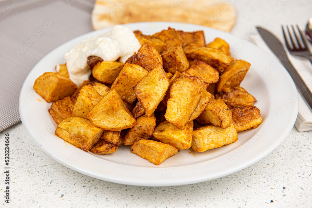 Baked potato wedges on white table background Baked potato wedges on white table background