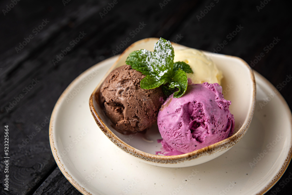 ice cream with chocolate and mint on a wooden background. ice cream with chocolate and mint on a wooden background.