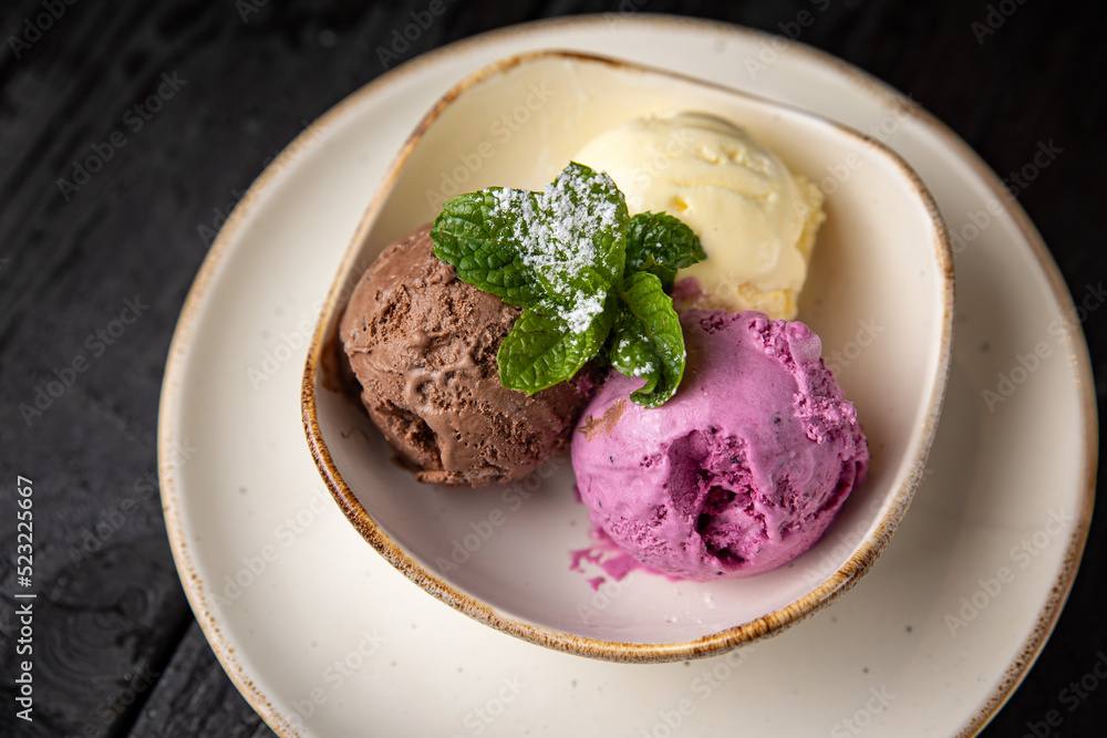 ice cream with chocolate and mint on a wooden background. ice cream with chocolate and mint on a wooden background.