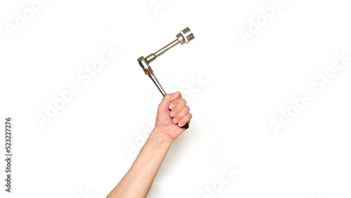 Male hand holding a socket wrench on a white background