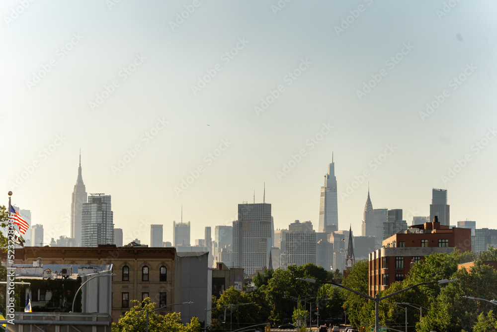 View of the Manhattan Skyline From the residential area with American Flag on the side