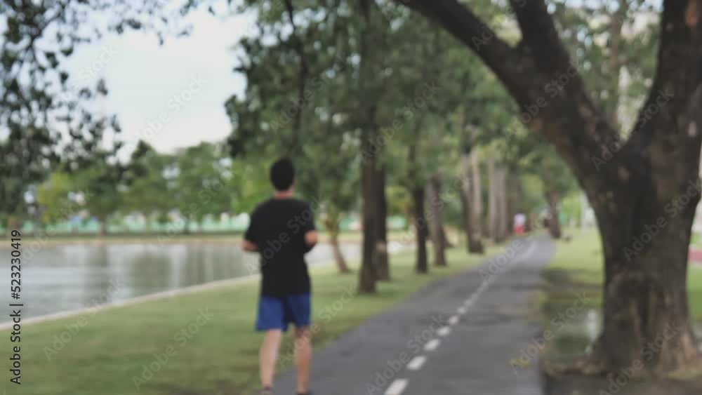 The Man running the park.It must be blurred to protect it from copyright protection. The Man running the park.It must be blurred to protect it from copyright protection.
