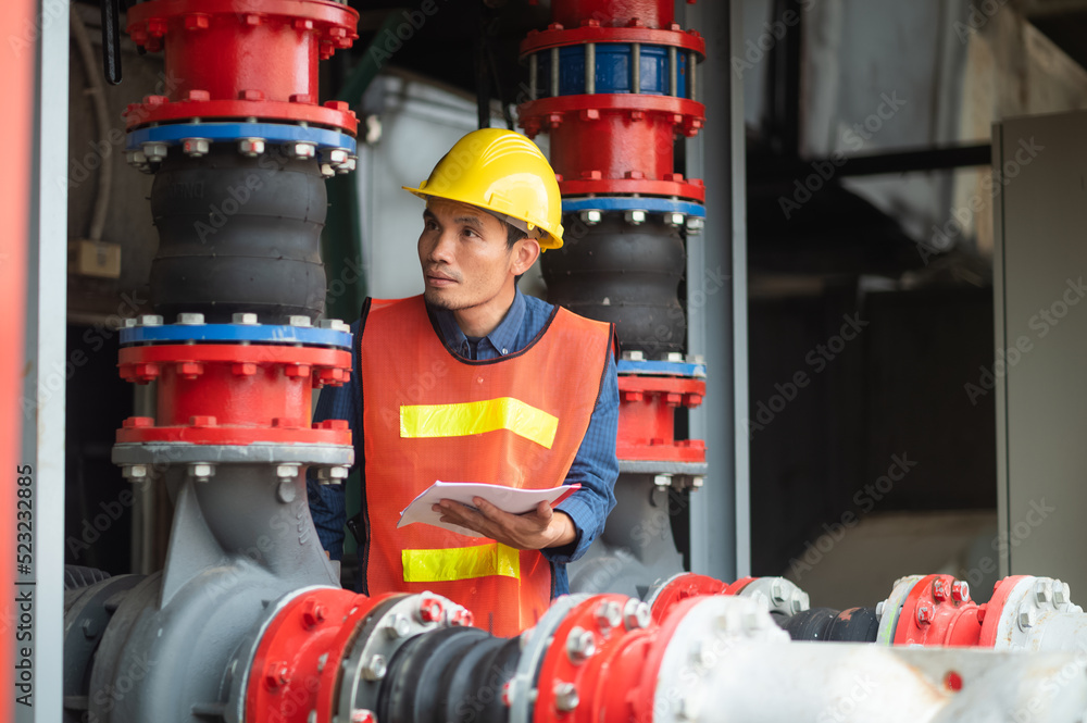 Asian man engineer are working in factory and checking safety system control on production industrial Asian man engineer are working in factory and checking safety system control on production industrial
