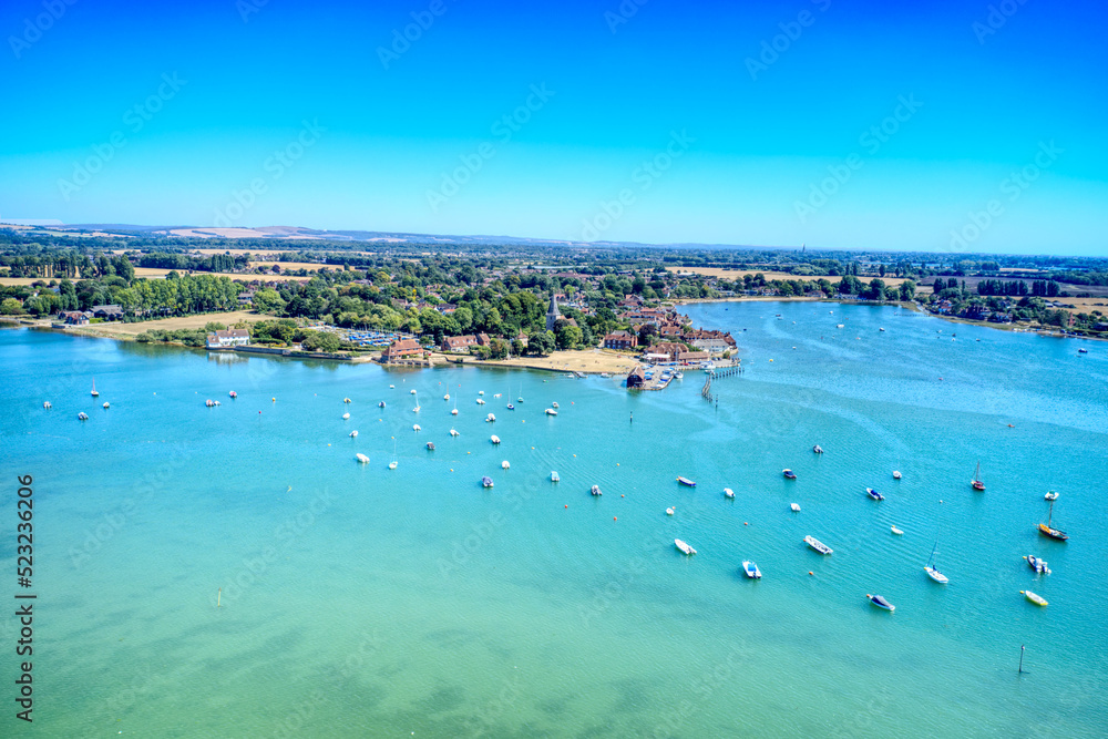 Aerial view over small boats and Sailing Dinghies anchored in the beautiful estuary at Bosham in Southern England. Aerial view over small boats and Sailing Dinghies anchored in the beautiful estuary at Bosham in Southern England.