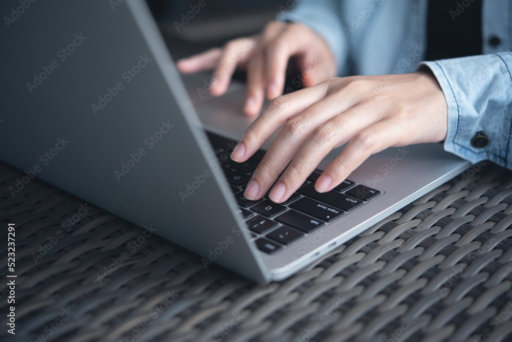 Business woman typing, working on laptop computer on table at coffee shop, connecting the internet Business woman typing, working on laptop computer on table at coffee shop, connecting the internet
