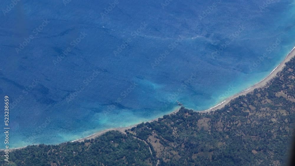 Aerial shot of tropical volcanic islands from plane Aerial shot of tropical volcanic islands from plane