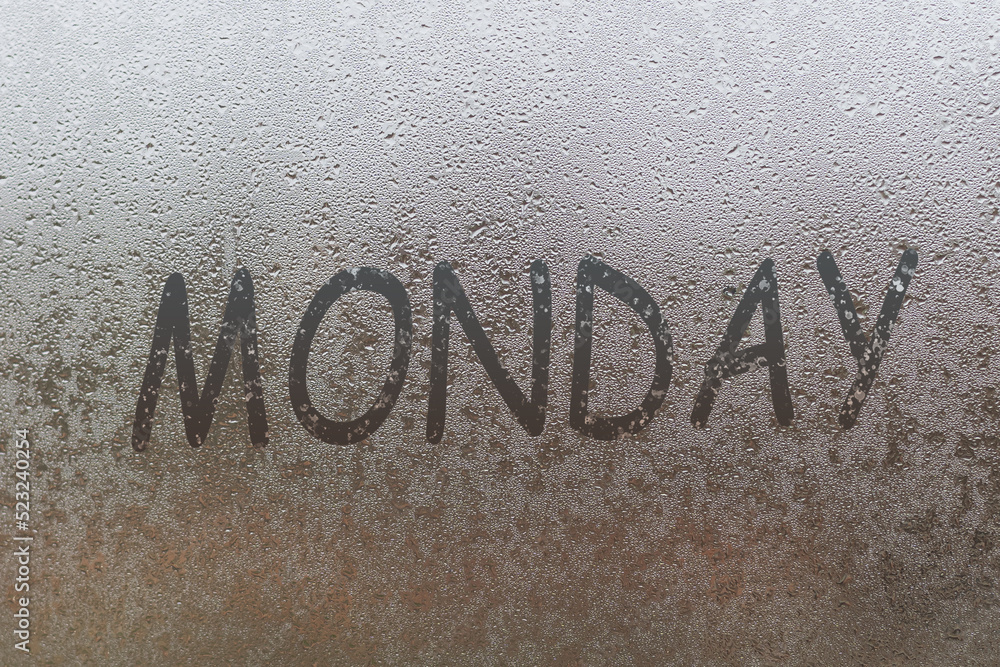 Fototapeta premium MONDAY written on the glass screen with raindrops background. Mood of working every start of the week.