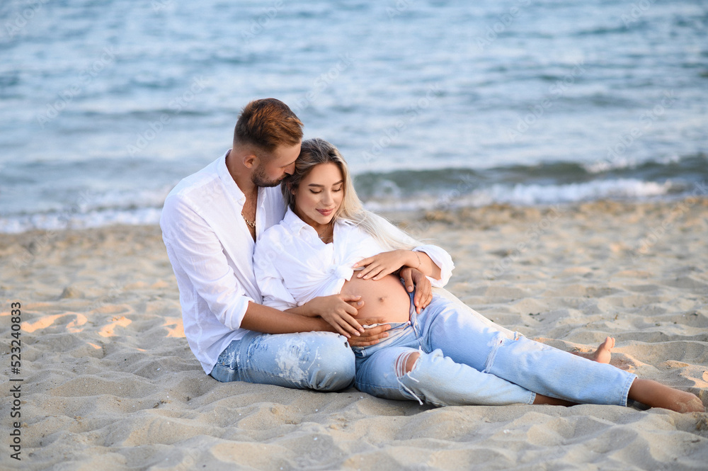 Pregnancy Happiness.Cute Family Moments, Parents-To-Be. Side View, Copy Space. Happy pregnancy woman and husband hugging pregnant belly.  Concept of pregnancy, maternity, expectation for baby birth.