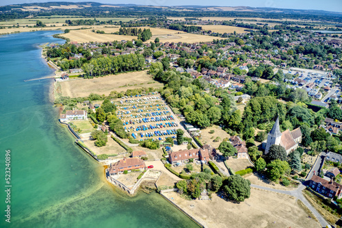 Aerial over the beautiful village of Bosham, a popular sailing location in West Sussex England on the banks of the estuary.