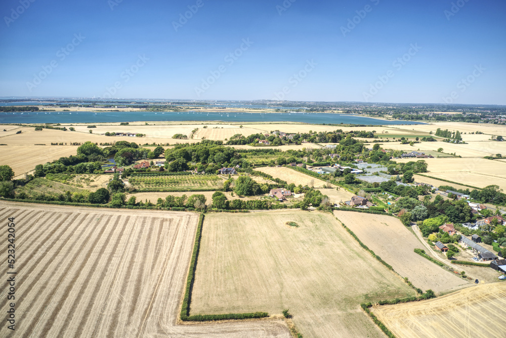 Aerial photo of the small Parish of Chidham in West Sussex surrounded by fields between the estuary of Bosham and Thornham Marina.
