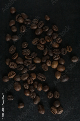 Roasted coffee beans on a dark background. Coffee beans. Cup of coffee. Coffee theme. Type of drink. Coffee house. 