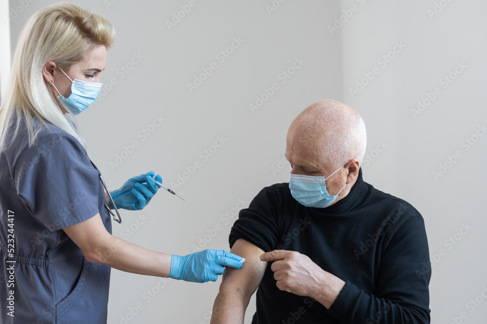 Fototapeta premium elderly man getting coronavirus vaccine