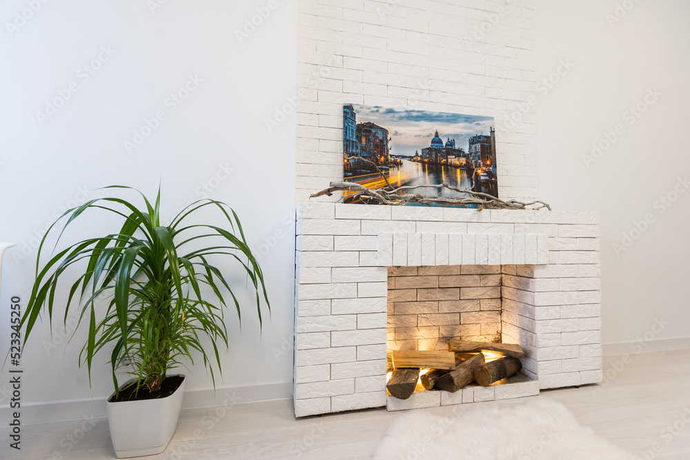 Fototapeta premium Modern interior house with bright living room, fire in new fireplace, wall on background