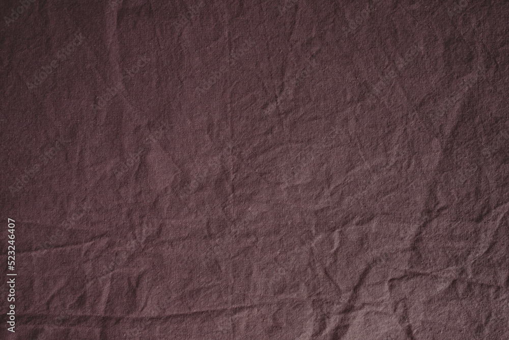 Fototapeta premium Textured fabric in the color of a dusty rose. Fabric background. Crumpled bed. Cotton texture. Calico bed sheet. Pink material. Home comfort. Textile industry.