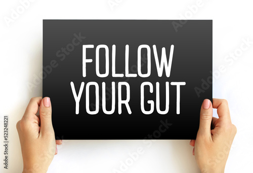 Follow Your Gut text on card, concept background