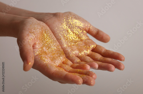Gold Glitter on hands. Gratitude, Magic, Star dust, Spirituality concept