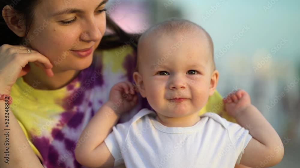 Mom and her little son are relaxing in the park. Portrait of a mother with a child on the street Mom and her little son are relaxing in the park. Portrait of a mother with a child on the street