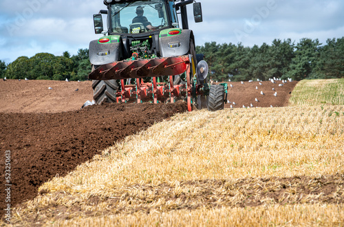 Photo A tractor ploughing  in the Scottish Borders
