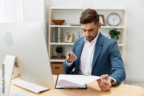 handsome businessman sitting at the computer work boss documentation isolated background