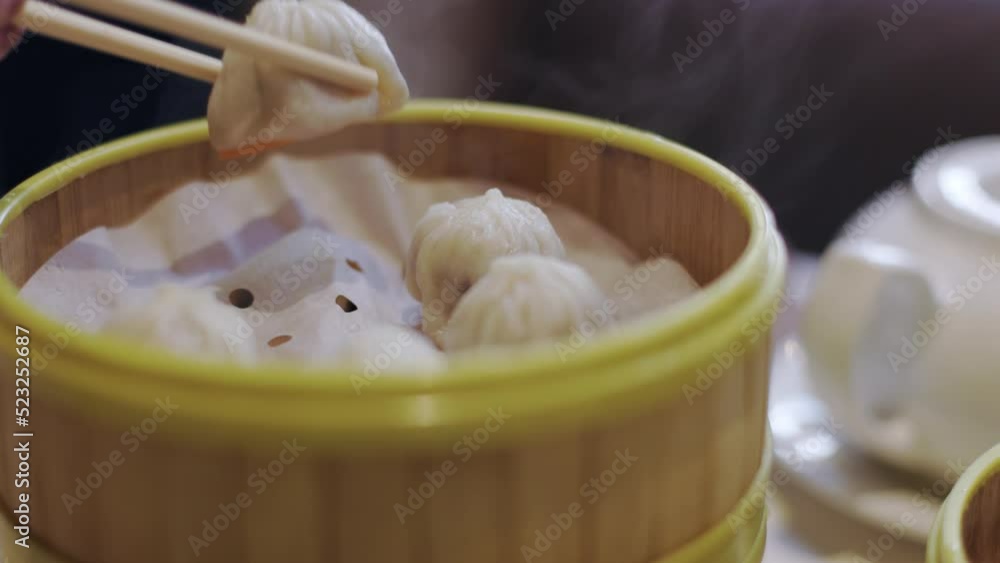 Hot fresh steaming dim sum, Chinese restaurant, eating delicious food, dumplings. 4K 24FPS. Hot fresh steaming dim sum, Chinese restaurant, eating delicious food, dumplings. 4K 24FPS.