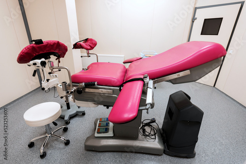 modern, multifunctional pink gynecological chair in the center of the room