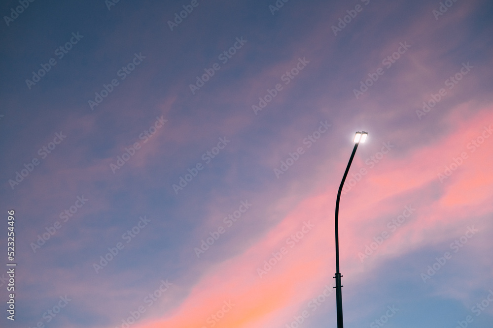 Lamppost at sunset . Sunset time. Copy space. An article about electricity.