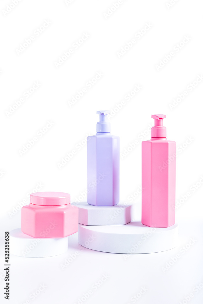 Colorful neon cosmetic tubes on white round podiums Colorful neon cosmetic tubes on white round podiums