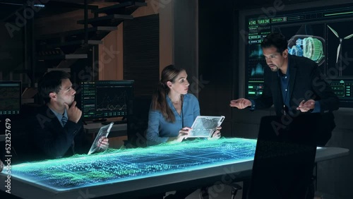 Team Meeting of Renewable Energy Engineers Working on Design of Innovative More Efficient Wind Turbines. Group of Specialists Gathered Around Holographic AR Table. Wind Farm generating Green Energy.