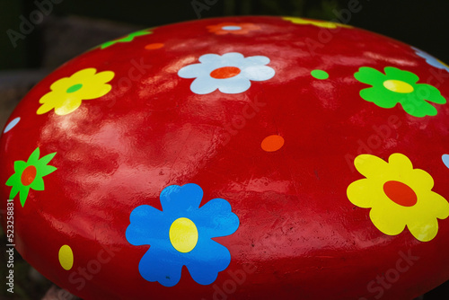 The surface of the red color with painted colors. Freshly painted Beast mushroom for children