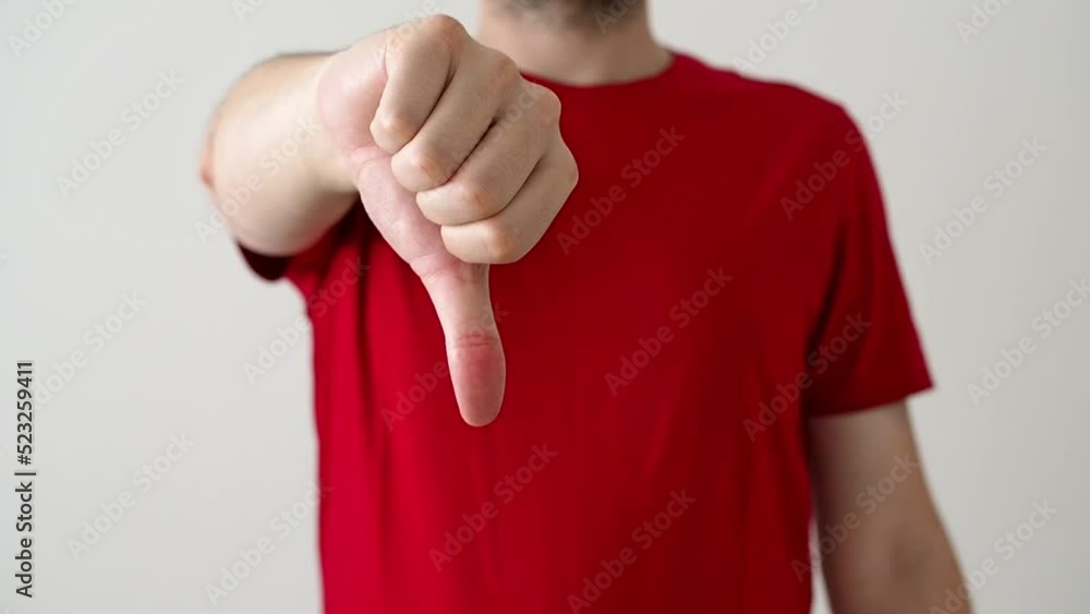 Unrecognizable man showing thumb down Unrecognizable man showing thumb down