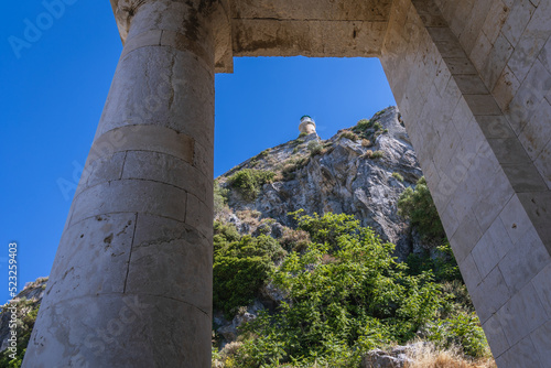 Columns of St George Church and lighthouse in Old Fortress in Corfu on Corfu Island in Greece