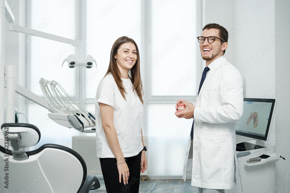 Fototapeta premium Female patient have a conversation with dentist in dental office