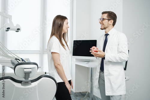 Female patient have a conversation with dentist in dental office