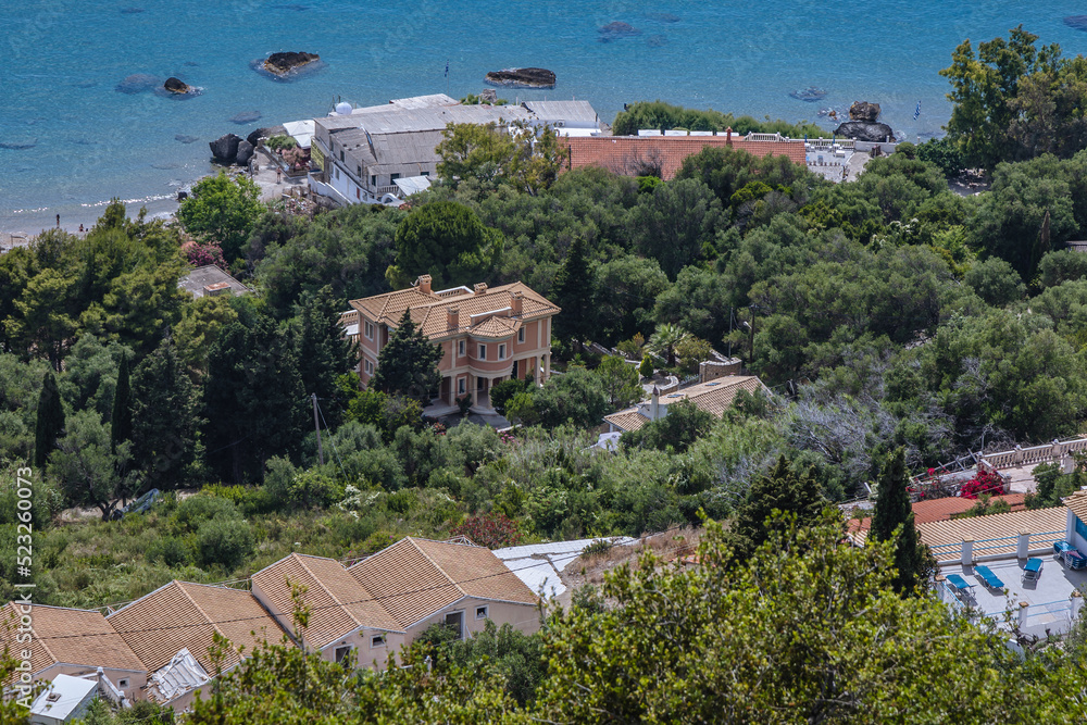 Houses on Ionian Sea shore in Agios Gordios village, Corfu Island, Greece