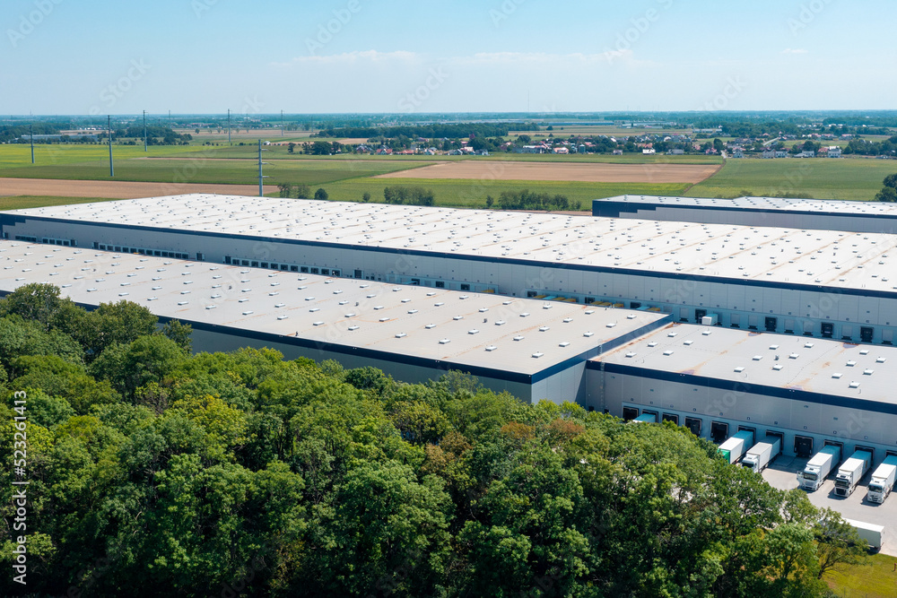 Aerial view of a warehouse of goods for online stores. Logistics center in the industrial zone of the city from above.