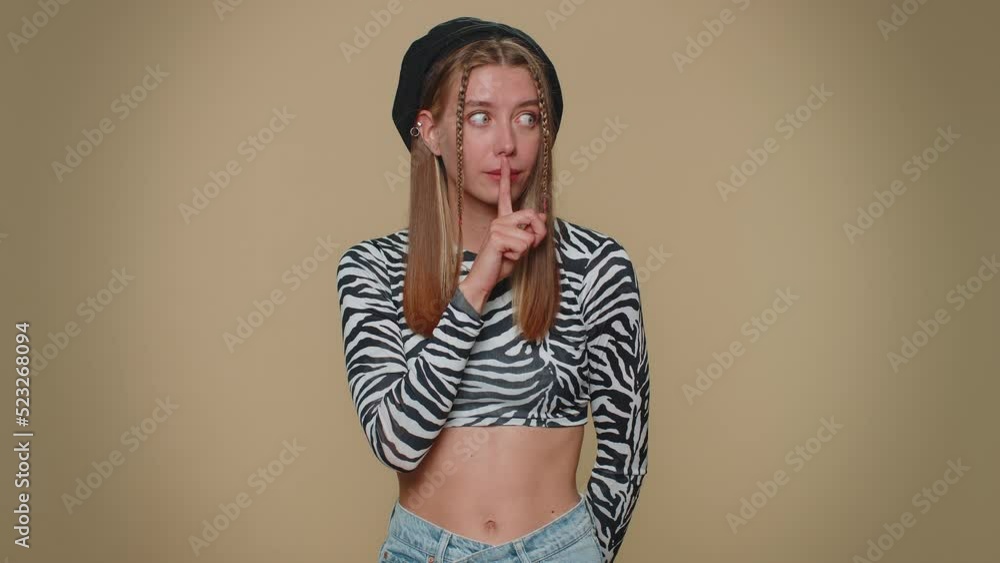 Shh be quiet please. Pretty young scared woman presses index finger to lips makes silence gesture sign do not tells secret. Adult stylish female girl isolated alone on beige studio background indoors Shh be quiet please. Pretty young scared woman presses index finger to lips makes silence gesture sign do not tells secret. Adult stylish female girl isolated alone on beige studio background indoors