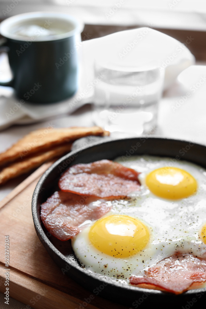 Tasty fried eggs with bacon on table, closeup. Space for text Tasty fried eggs with bacon on table, closeup. Space for text