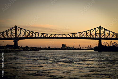 2022: Beautiful Sunrise in Old Port, clock tower and Jacques Cartier Bridge against sunset sky, Montreal, Canada photo