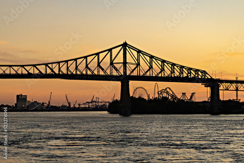 Beautiful Sunrise in Old Port, clock tower and Jacques Cartier Bridge against sunset sky, Montreal, Canada photo
