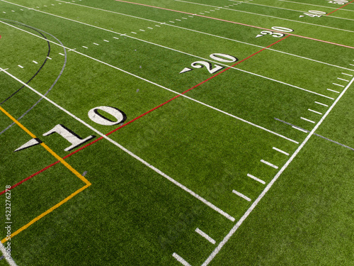 Aerial image of a typical synthetic turf football field 10 yard line in white. 