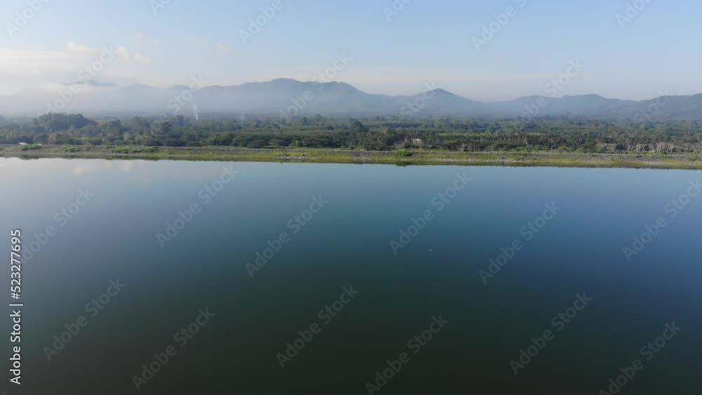 Morning sunrise on river dam with mountain aerial movement view nature scene Morning sunrise on river dam with mountain aerial movement view nature scene