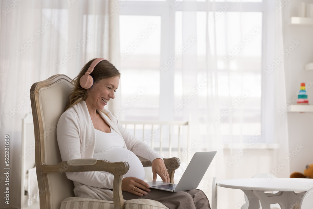 Pretty pregnant woman in headphones sit on armchair with laptop, smile enjoy video call with ob-gyn, receive professional medical on-line consultation, distance prenatal care, virtual meeting concept Pretty pregnant woman in headphones sit on armchair with laptop, smile enjoy video call with ob-gyn, receive professional medical on-line consultation, distance prenatal care, virtual meeting concept