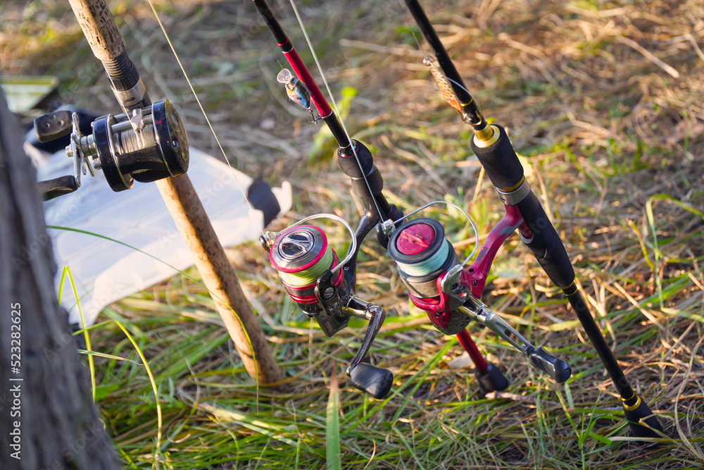Spinning rods with reels and lures ready for fishing Spinning rods with reels and lures ready for fishing