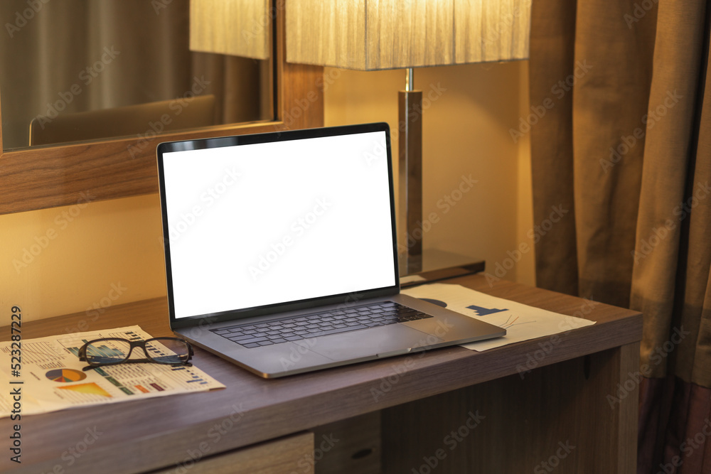Laptop with blank screen on table in hotel room or home, mockup. Empty screen for advertise concept Laptop with blank screen on table in hotel room or home, mockup. Empty screen for advertise concept