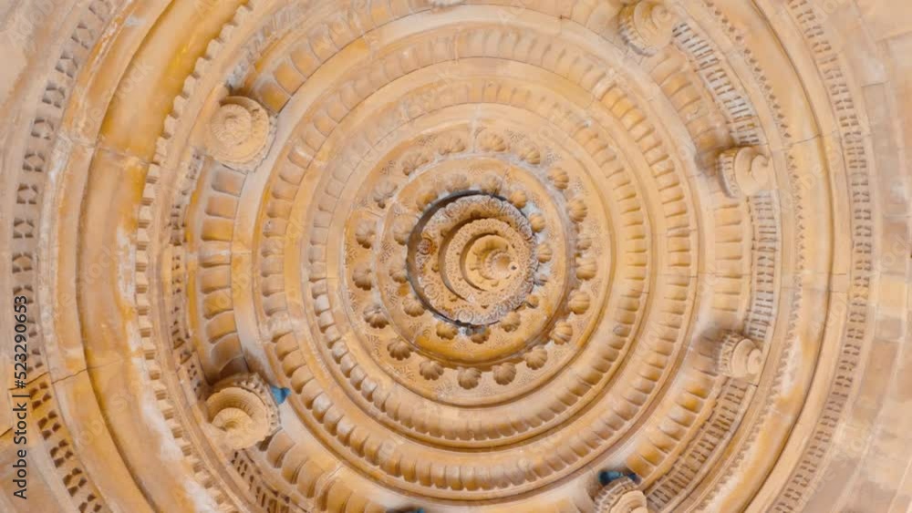 4K shot of the carved dome of the cenotaphs from below at Bada Bagh in Jaisalmer, Rajasthan, India. Ancient carvings on the roof of the dome made out of sandstone. Carved ceiling at Bada bagh cenotaph 4K shot of the carved dome of the cenotaphs from below at Bada Bagh in Jaisalmer, Rajasthan, India. Ancient carvings on the roof of the dome made out of sandstone. Carved ceiling at Bada bagh cenotaph