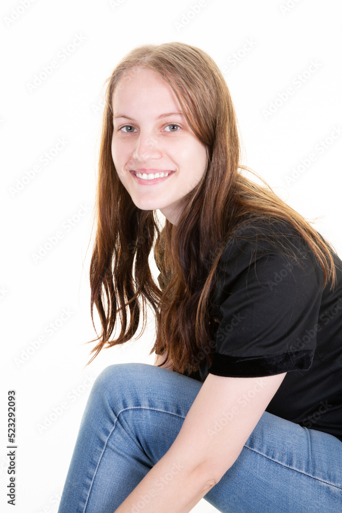 Joyful pretty young woman smile positively in casual attire shirt jeans poses against white background Joyful pretty young woman smile positively in casual attire shirt jeans poses against white background
