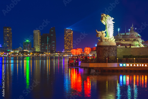 skyline of da nang by han river with carp dragon photo